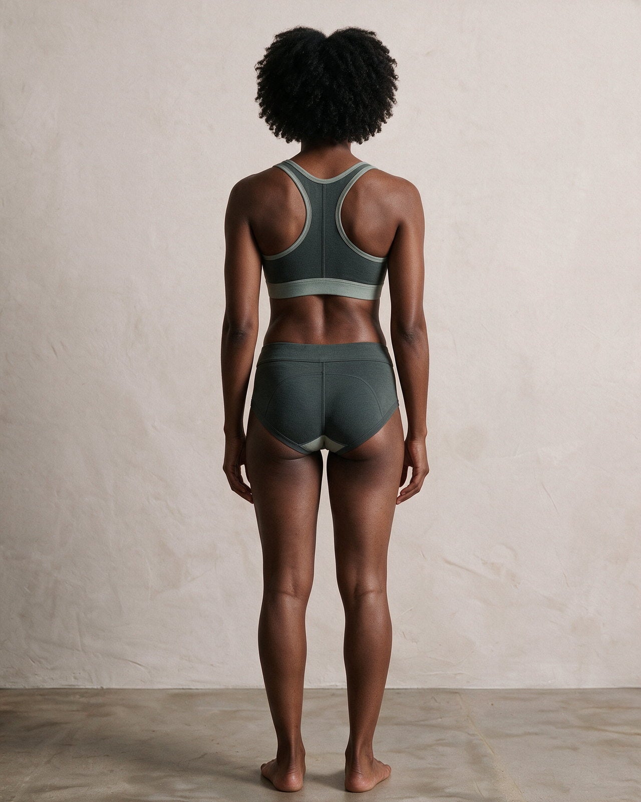 Model 02, back view, wearing the hæld Neo-Form set